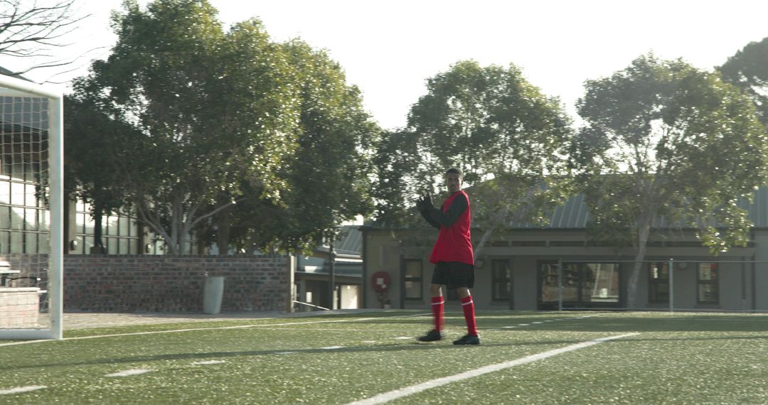 Referee Observing Soccer Players Practicing on Sunny Field