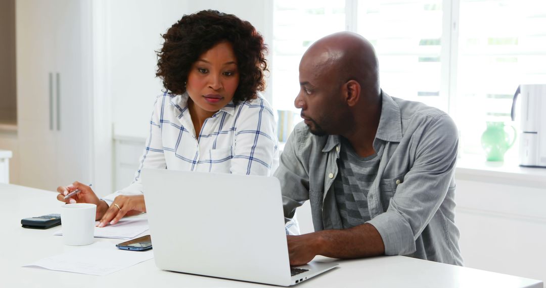 Focused Professionals Collaborating on Laptop Project