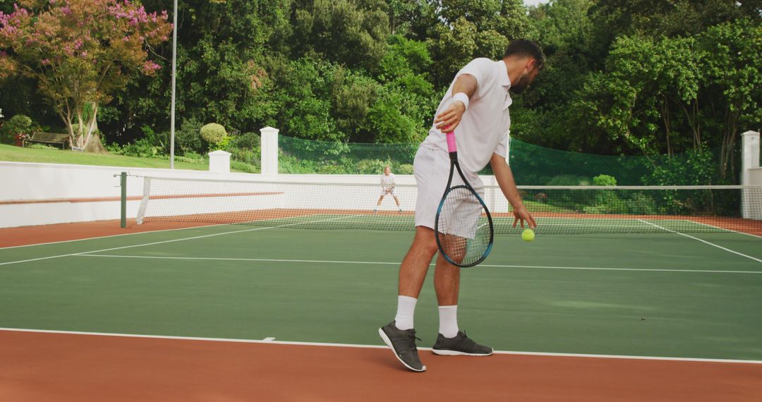 Athletic Man Serving Tennis Ball on Outdoor Court - Free Images, Stock Photos and Pictures on Pikwizard.com