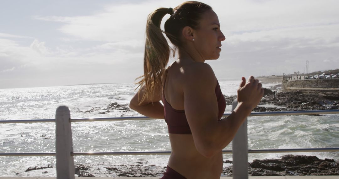 Determined Female Athlete Jogging Along Coastal Path - Free Images, Stock Photos and Pictures on Pikwizard.com