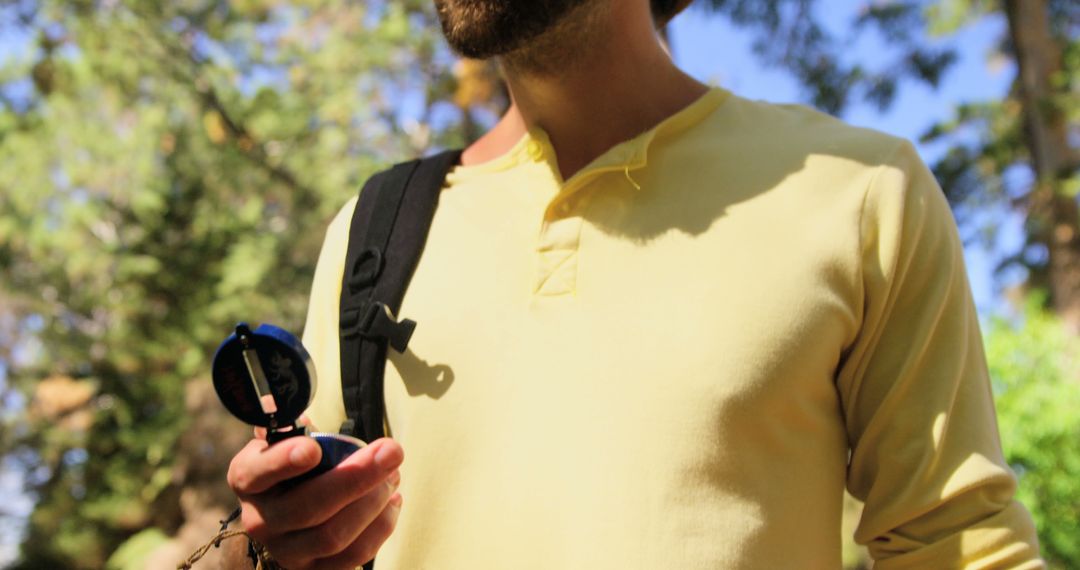 Man Hiking in Forest Holding Compass - Free Images, Stock Photos and Pictures on Pikwizard.com