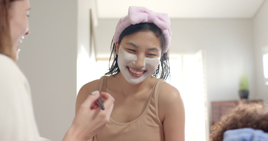 Diverse Friends Enjoying Relaxation with Facial Masks in Bedroom
