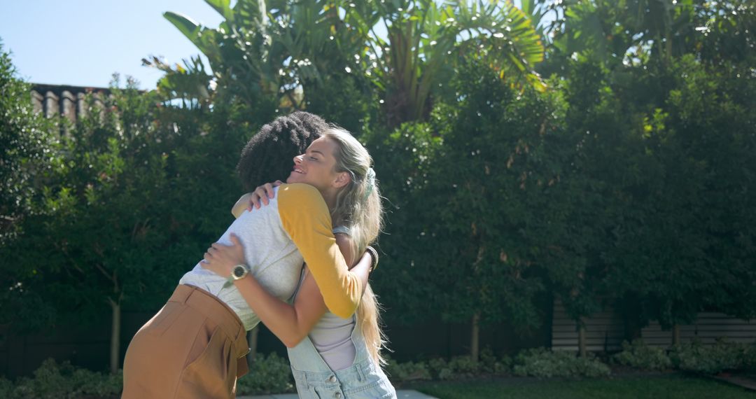 Diverse Friends Hugging on Patio in Suburban Backyard