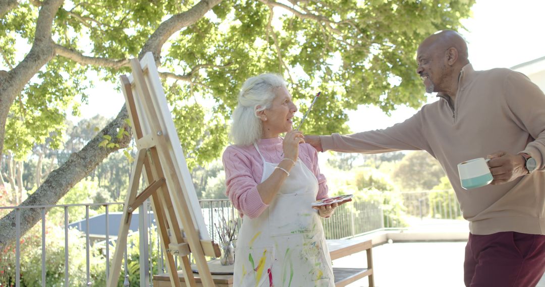 Senior Couple Painting Canvas Outdoors on Sunny Day - Free Images, Stock Photos and Pictures on Pikwizard.com