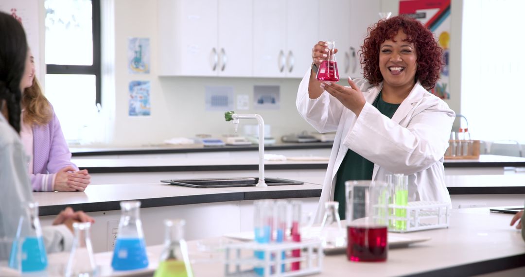 Teacher Conducting Experiment Holding Red Flask in Science Laboratory