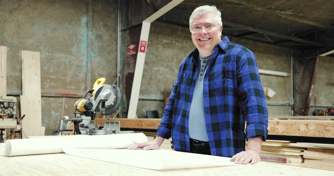 Smiling Carpenter in Workshop Embracing Craftsmanship - Free Images, Stock Photos and Pictures on Pikwizard.com