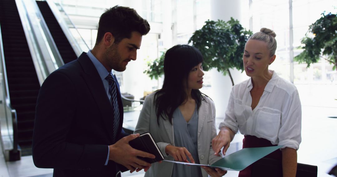 Business Team Discussing Project in Modern Corporate Lobby