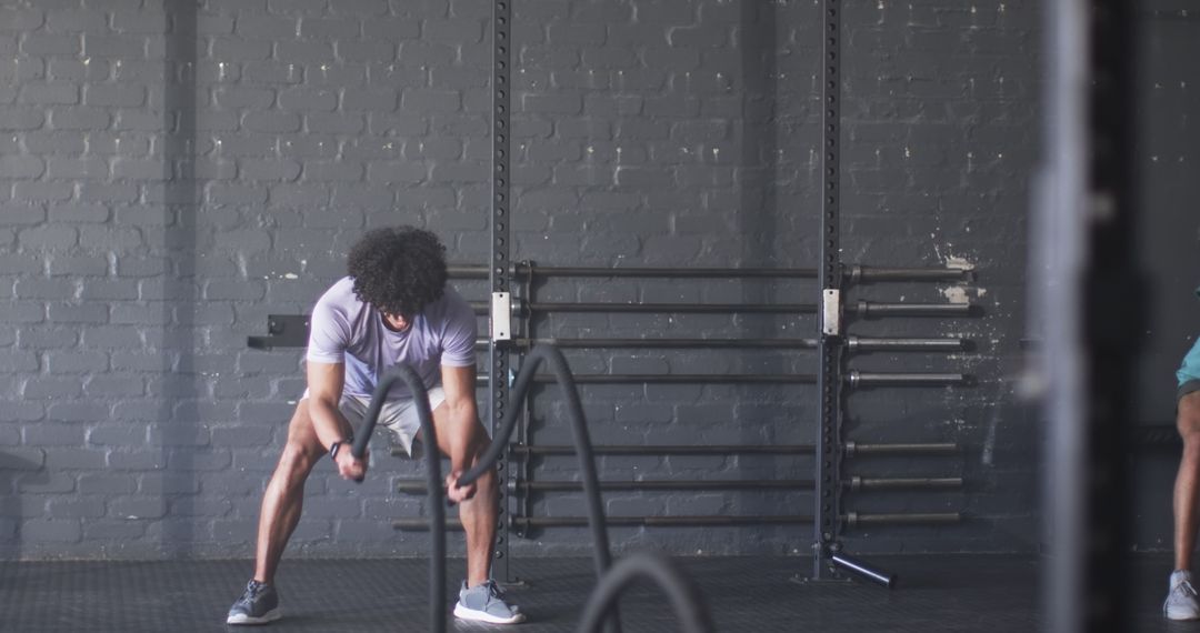 Man Taking a Break from Fitness Workout in Gym