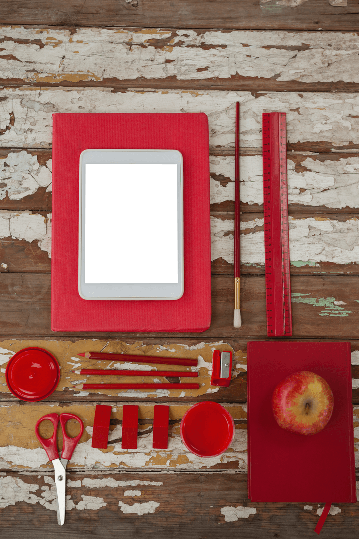 Transparent Digital Tablet with Red School Supplies on Rustic Table