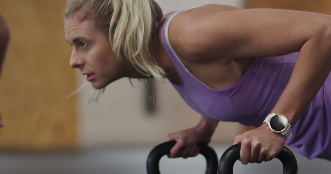 Fit Blonde Woman Doing Push-Ups With Kettlebells in Gym - Free Images, Stock Photos and Pictures on Pikwizard.com