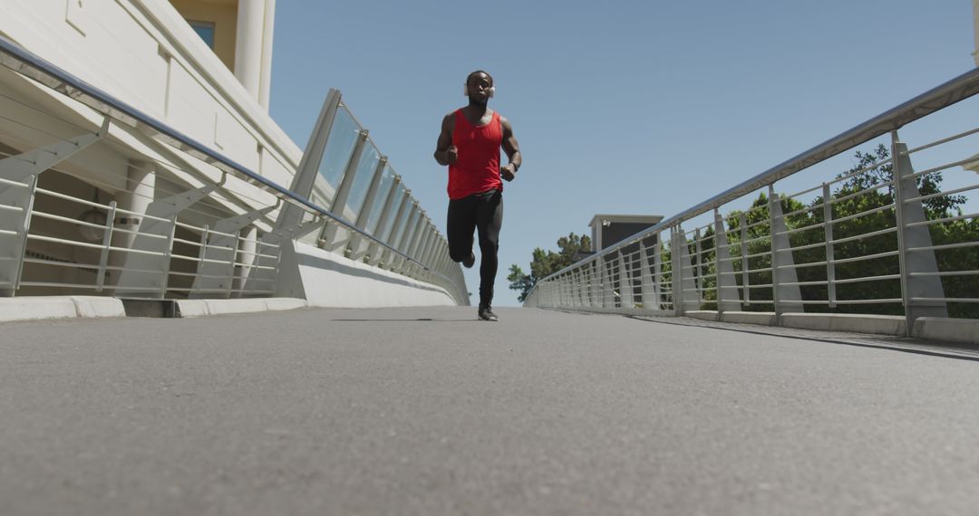 Athlete Running on Urban Bridge in Bright Red Tank Top - Free Images, Stock Photos and Pictures on Pikwizard.com