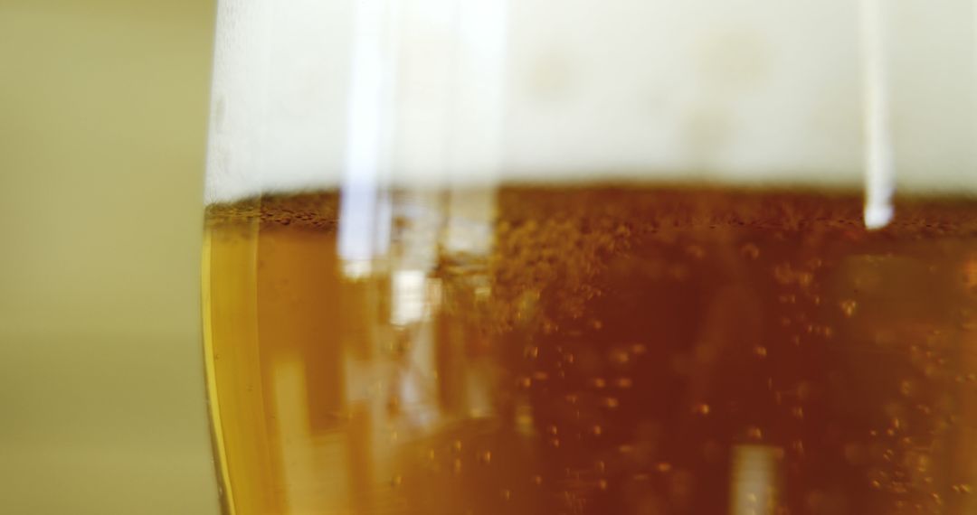 Close-up of frothy cold beer in glass with bubbles - Free Images, Stock Photos and Pictures on Pikwizard.com