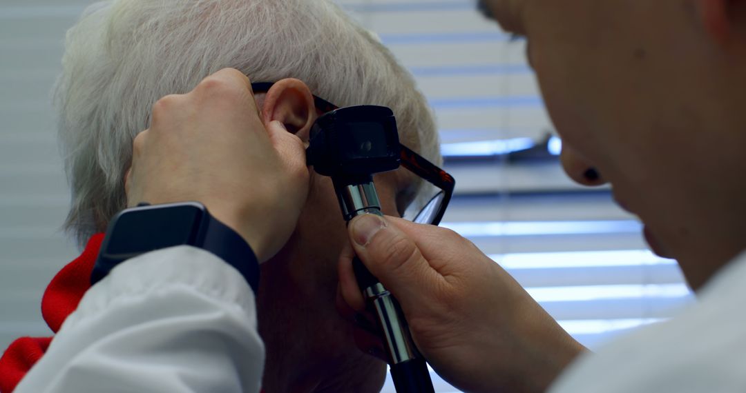 Doctor Conducting Ear Examination on Elderly Patient in Clinic - Free Images, Stock Photos and Pictures on Pikwizard.com