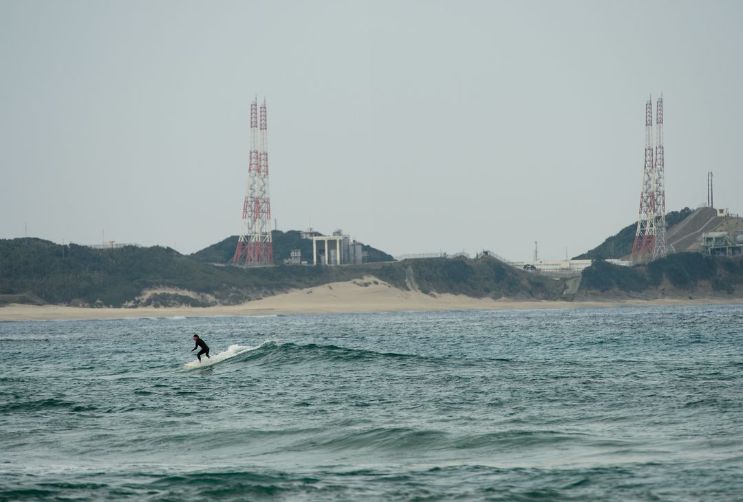 Surfer Navigating Waters Near Tanegashima Space Center, Japan - Free Images, Stock Photos and Pictures on Pikwizard.com