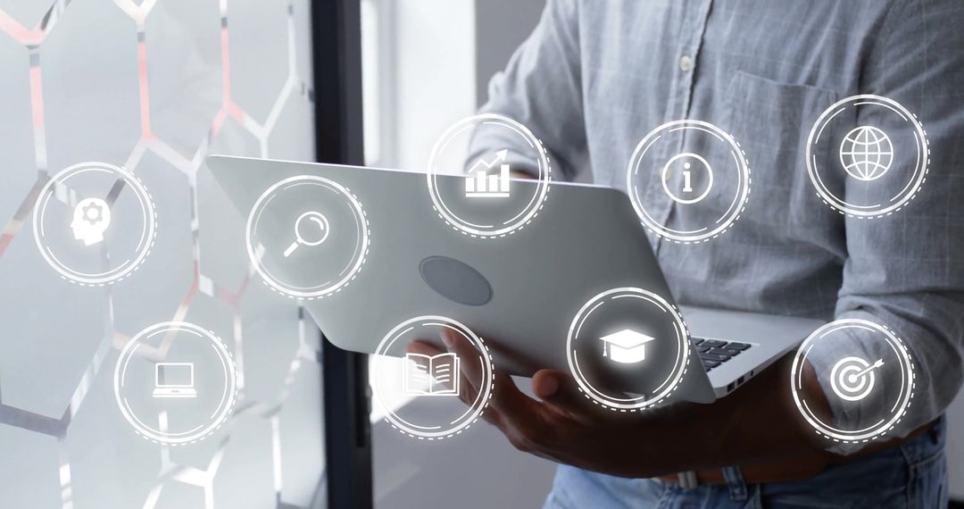 Businessman Using Laptop with Digital Interface Symbols Overlay