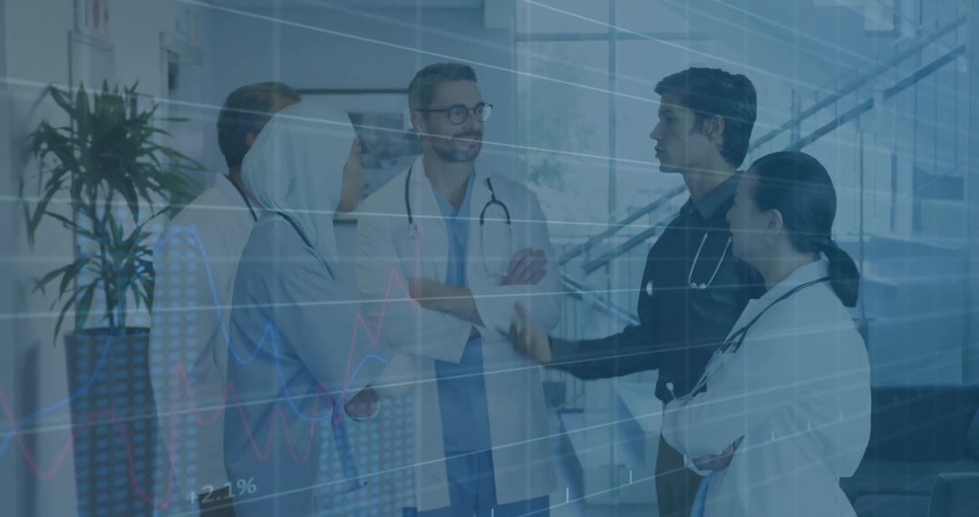 Medical Team Analyzing Data Trends in Hospital Corridor