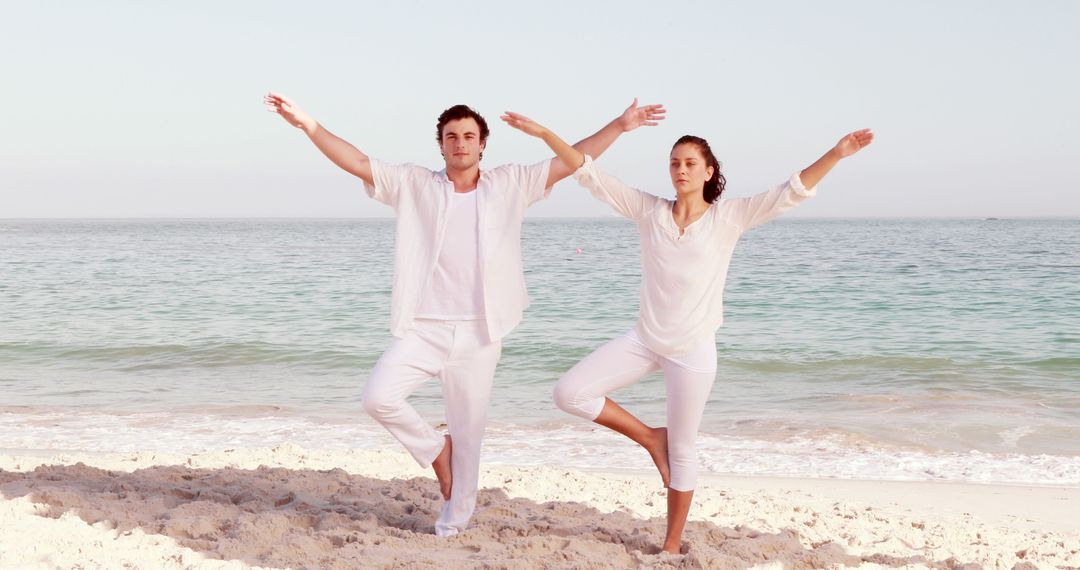 Couple Practicing Yoga on Sandy Beach at Sunrise - Free Images, Stock Photos and Pictures on Pikwizard.com