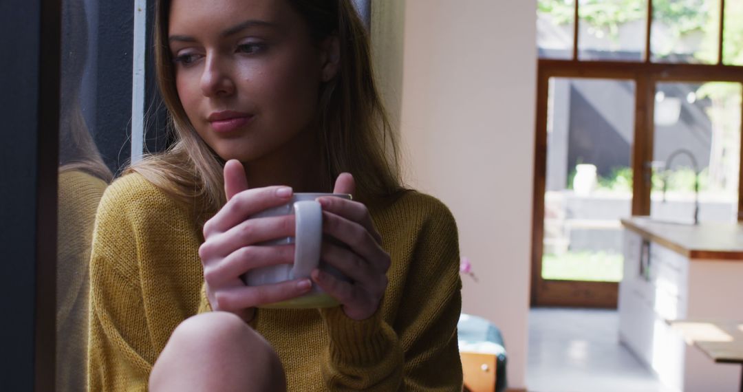 Woman Sipping Coffee Relaxing at Home by the Window - Free Images, Stock Photos and Pictures on Pikwizard.com