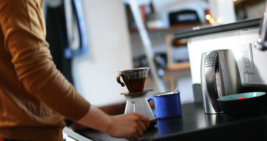 Person Preparing Pour Over Coffee in Modern Kitchen - Free Images, Stock Photos and Pictures on Pikwizard.com