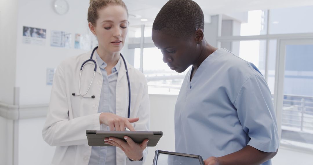 Medical Team Collaborating Using Digital Tablet in Hospital - Free Images, Stock Photos and Pictures on Pikwizard.com