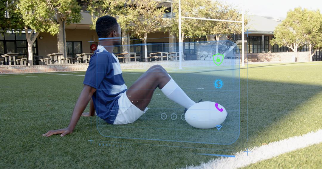 Athlete sitting on turf controlling augmented reality sports performance dashboard