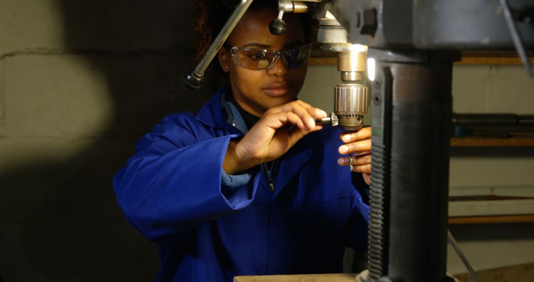 Female Worker Adjusting Machine in Industrial Setting - Free Images, Stock Photos and Pictures on Pikwizard.com