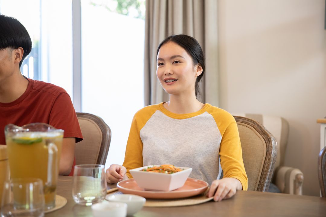 Young Couple Enjoying Meal Together at Dining Table