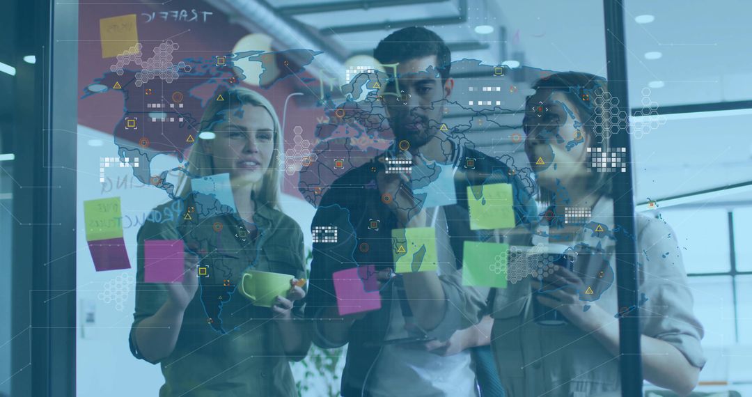 Young Team Brainstorming Around Glass Board with Sticky Notes and Global Strategy Overlay