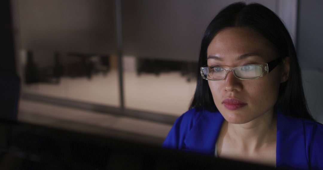 Image of asian businesswoman in glasses staring at computer screen, working at night in office - Free Images, Stock Photos and Pictures on Pikwizard.com