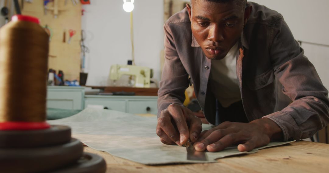 Skilled Craftsman Cutting Leather at Artisan Workshop