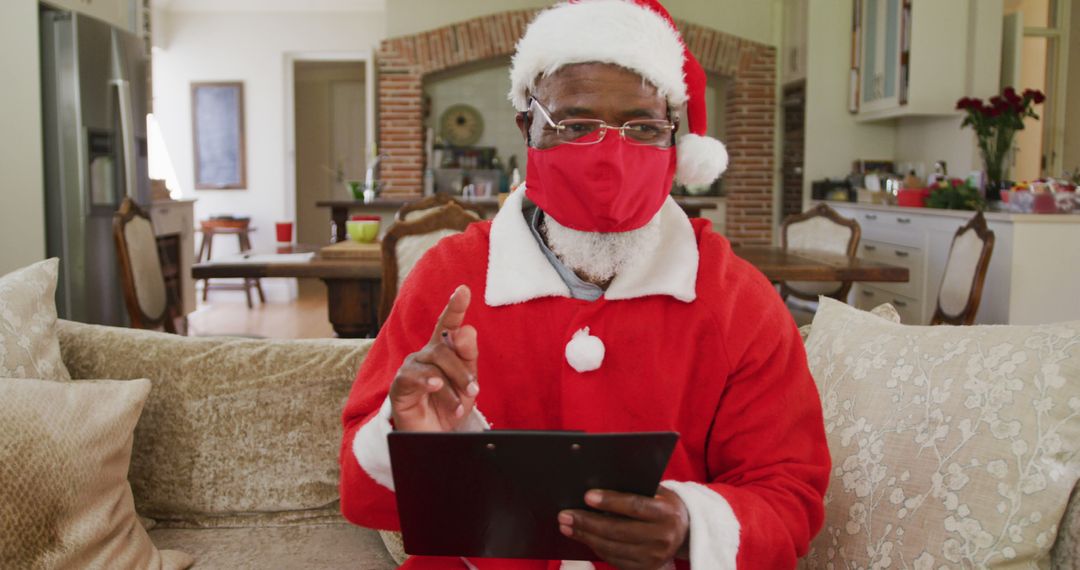 African American Santa Claus Holding Tablet on Video Call at Home - Free Images, Stock Photos and Pictures on Pikwizard.com