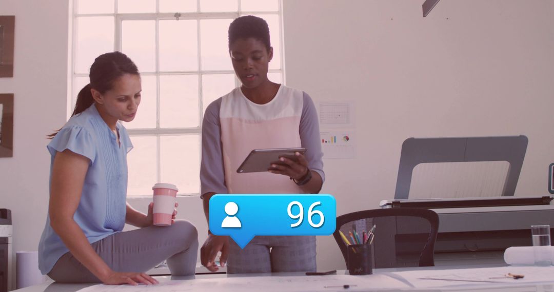 Designers Collaborating on Blueprints with Social Media Engagement