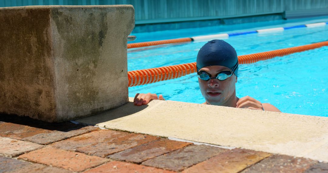 Male Swimmer Glancing Near Pool Steps with Smile - Free Images, Stock Photos and Pictures on Pikwizard.com