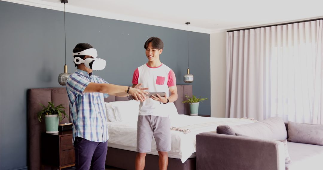 Father Using VR Headset with Son Observing at Home