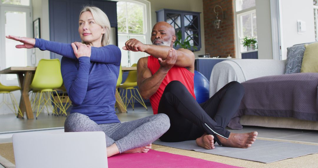 Senior Couple Practicing Yoga Together at Home