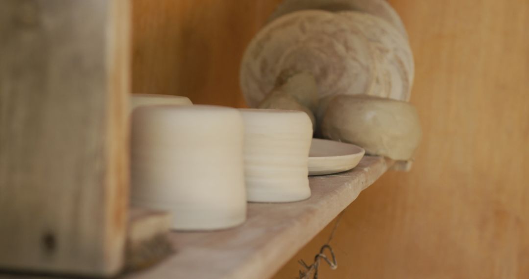 Handcrafted Pottery on Shelf in Artisan Workshop