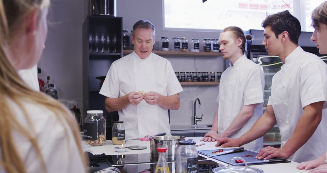 Chef Instructing Culinary Students in Kitchen - Free Images, Stock Photos and Pictures on Pikwizard.com