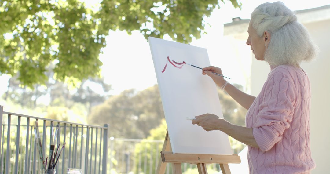 Senior Woman Painting on Canvas in Garden - Free Images, Stock Photos and Pictures on Pikwizard.com