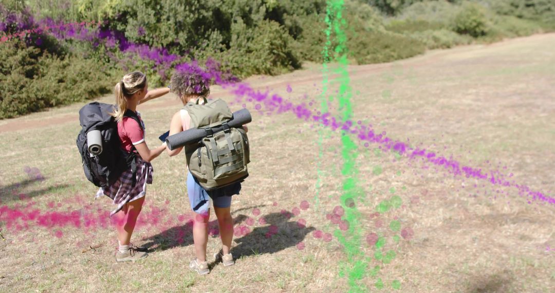 Two Hikers Exploring Trail Using Map with Backpacks and Rolled Mats in Sunny Meadow