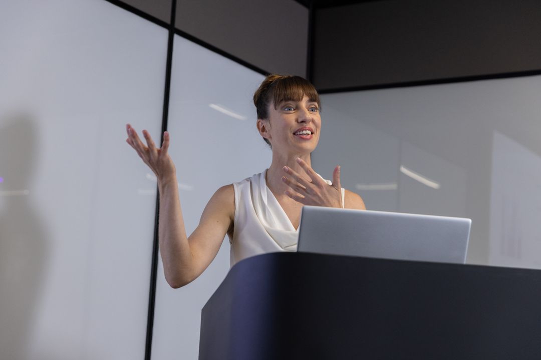 Confident Female Speaker Delivering Presentation in Modern Conference Room