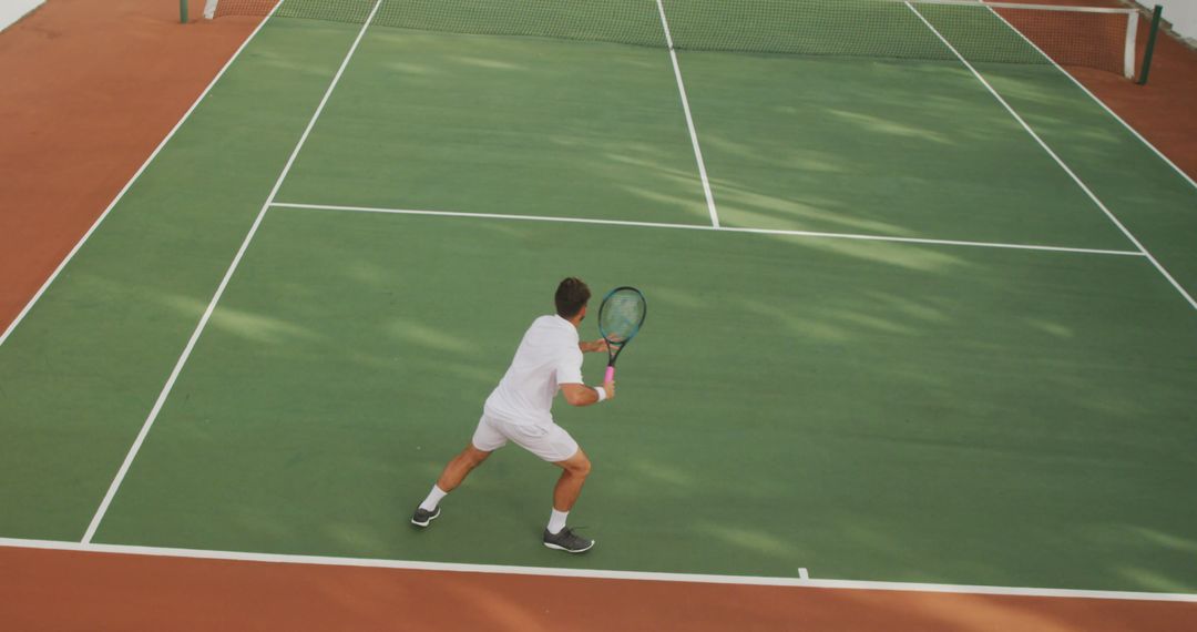 Male Tennis Player Preparing for Serve on Tennis Court - Free Images, Stock Photos and Pictures on Pikwizard.com