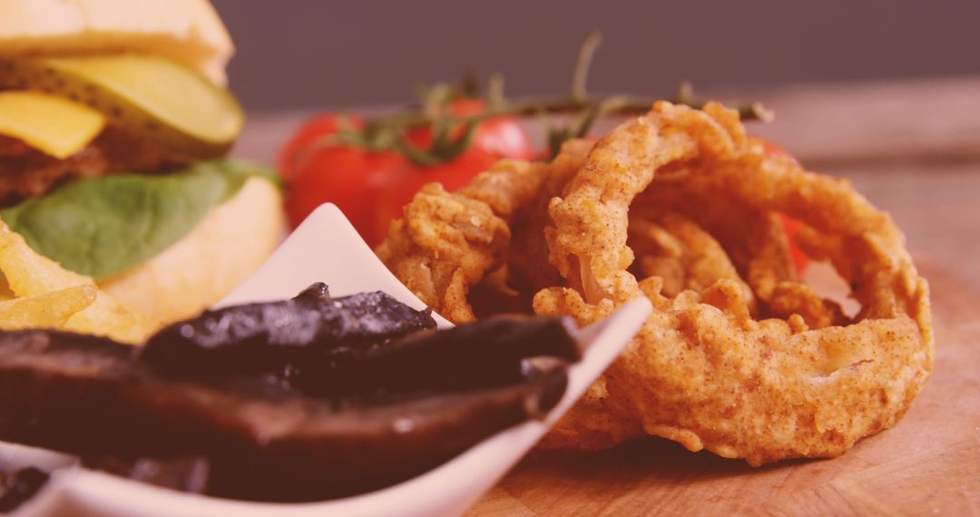Delicious Fast Food Spread with Onion Rings and Cheeseburger