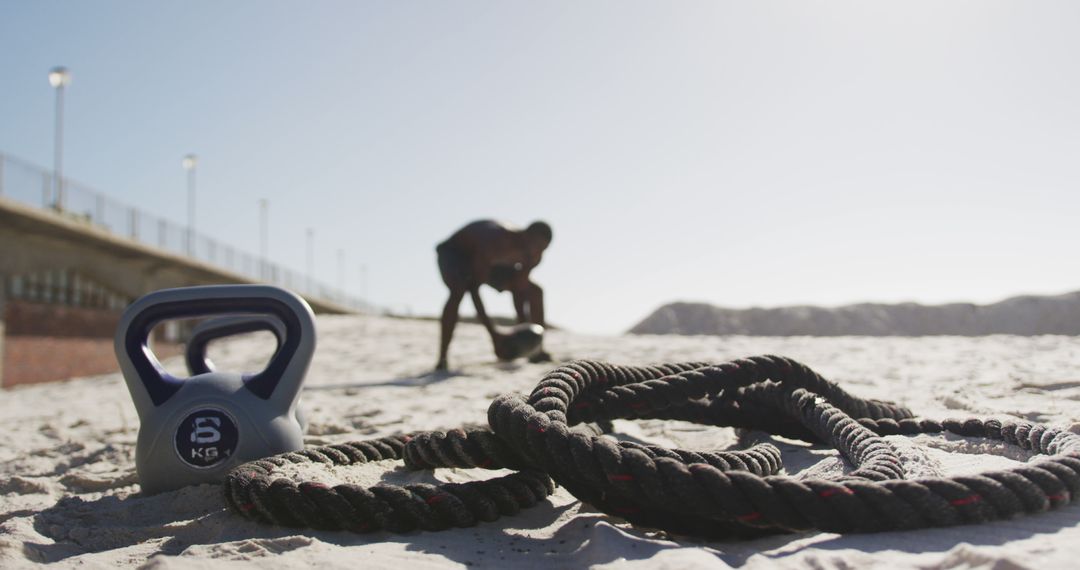 Person Exercising with Kettlebell and Battle Rope on Beach - Free Images, Stock Photos and Pictures on Pikwizard.com