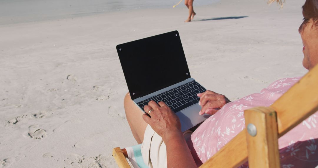 Senior Woman Relaxing on Beach with Laptop - Free Images, Stock Photos and Pictures on Pikwizard.com