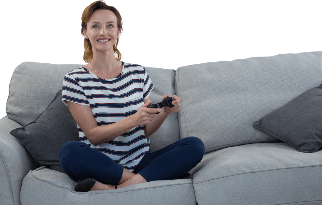 Smiling Woman with Game Controller Sitting Cross-Legged on Sofa Transparent Background