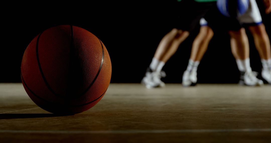 Basketball Close-Up with Players in Background - Free Images, Stock Photos and Pictures on Pikwizard.com