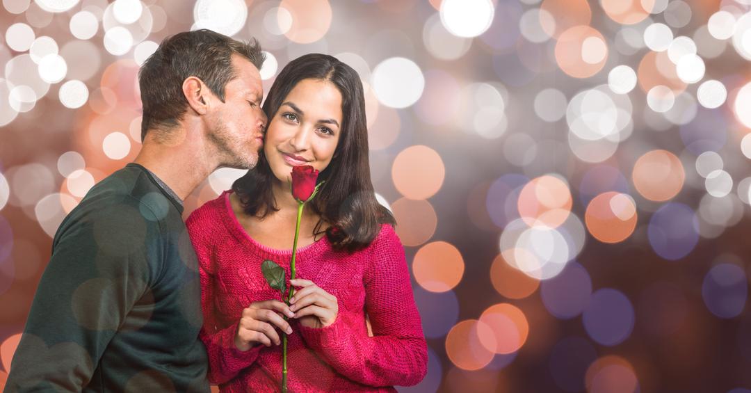 Man Romantically Kissing Woman Holding Rose with Bokeh Background - Free Images, Stock Photos and Pictures on Pikwizard.com