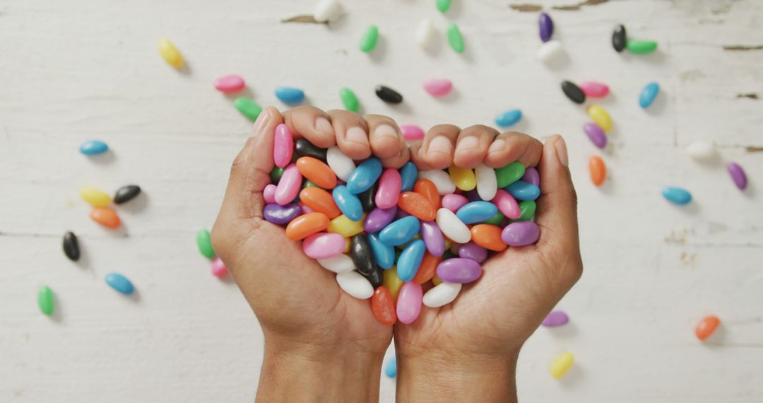 Hands Collecting Colorful Jellybeans in Heart Shape - Free Images, Stock Photos and Pictures on Pikwizard.com