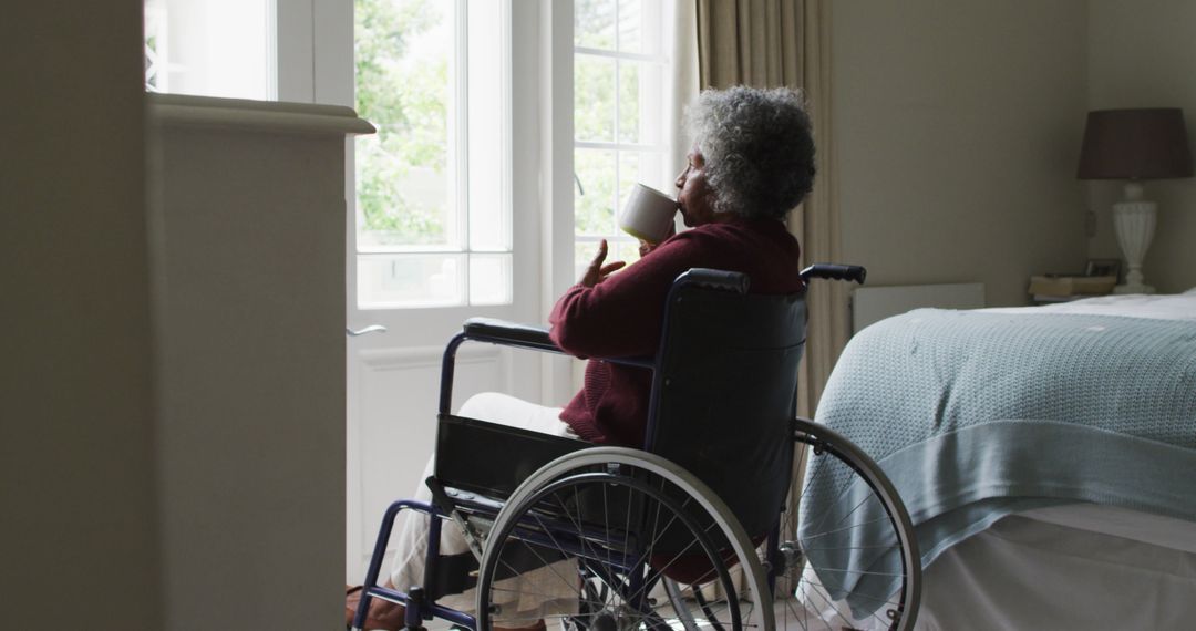 Senior Woman in Wheelchair Drinking Tea by Window in Cozy Bedroom - Free Images, Stock Photos and Pictures on Pikwizard.com