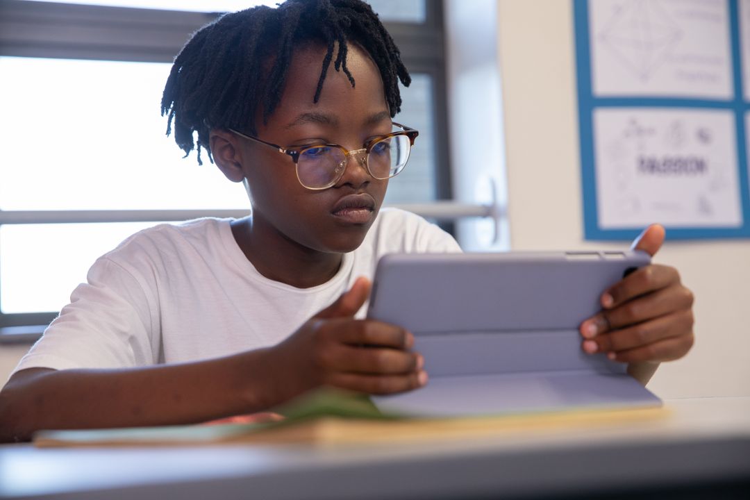 African American Boy Using Tablet in Classroom Setting